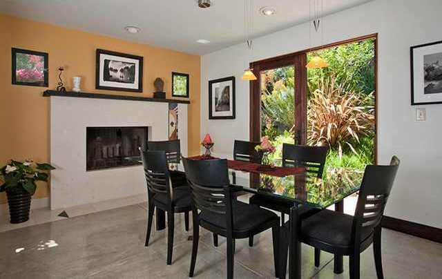 Open dining room with hearth and garden view