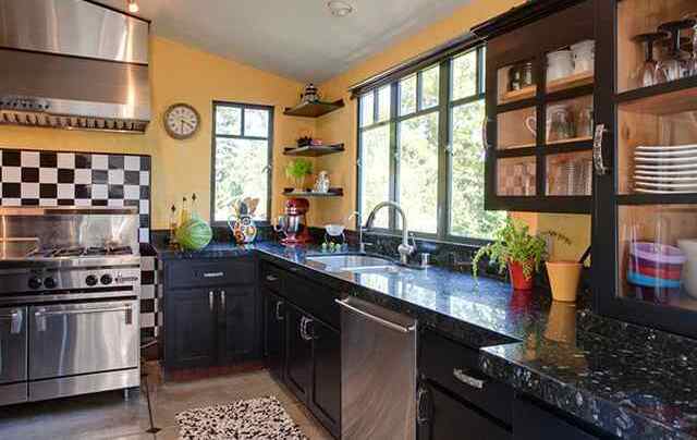 Kitchen with checkered tile, granite, and forest views