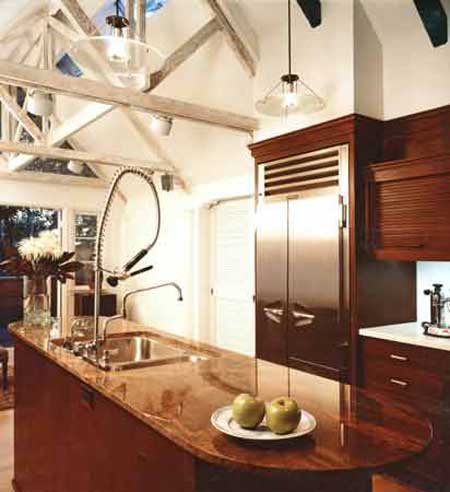 Vaulted kitchen with exposed king-post trusses and walnut cabinetry
